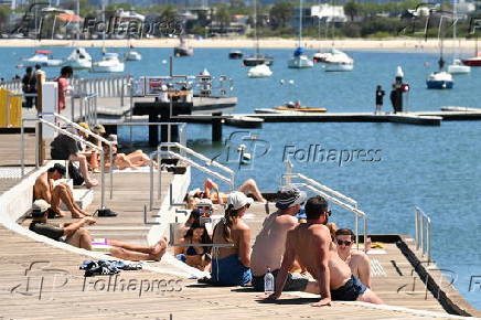 People relax on Melbourne St Kilda beach