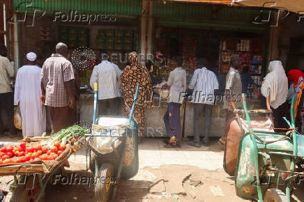 Sudanese buy their groceries from a local vendor during the month of Ramadan in the city of Omdurman