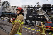 Emergency services continue work one day after fire engulfed historic Stock Exchange building