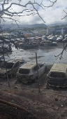Burnt cars in the aftermath of protests that turned violent, in Noumea