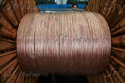 FILE PHOTO: An employee works at a electricity cable factory in Baoying