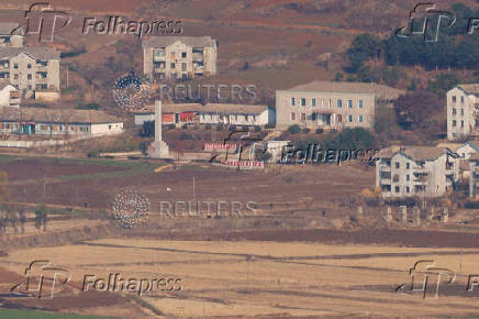 North Korean citizens walk in North Korea's propaganda village Kaepoong, in this picture taken from the top of the Aegibong Peak Observatory, south of the demilitarised zone (DMZ), separating the two Koreas in Gimpo