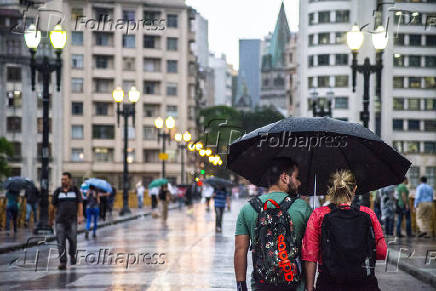 Pedestres enfrentam manh chuvosa no centro de SP