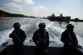 Members of Ecuador's Navy carry out a river patrol, Guayaquil