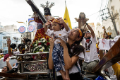 Filipino Catholics participate in the parade of Black Nazarene replicas