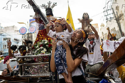 Filipino Catholics participate in the parade of Black Nazarene replicas