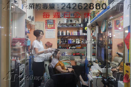 A woman gets her hair washed at a saloon in Keelung