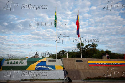 A man crosses the border towards Brazil after leaving Venezuela