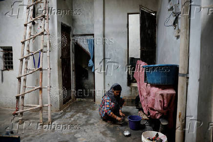 Nasreen washes utensils at her residence in Loni town in the northern state of Uttar Pradesh