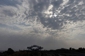 FILE PHOTO: People stand on a viewing platform overlooking the Taiwan strait at the 68-nautical-mile scenic spot, one of mainland China's closest points to the island of Taiwan, on Pingtan Island