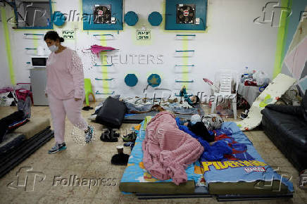 Israelis gather at a bomb shelter following rocket attacks from Lebanon towards Israel, in Acre