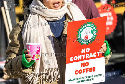 Workers picket in front of a Starbucks in the Brooklyn borough in New York