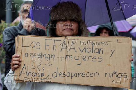 People gather to protest against the forced disappearance of four minors, in Quito