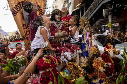 Filipino Catholics participate in the parade of Black Nazarene replicas