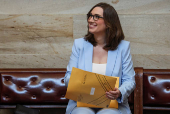 Incoming U.S. Representative Sarah McBride (D-DE) reacts as she holds a packet of new member information at the U.S. Capitol