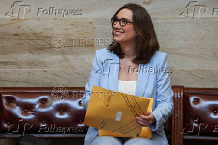 Incoming U.S. Representative Sarah McBride (D-DE) reacts as she holds a packet of new member information at the U.S. Capitol