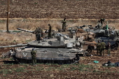 Israeli army soldiers and tanks gather in northern Israel