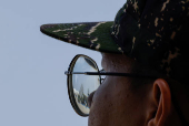 Hsiung Feng III and II mobile missile launchers are seen reflected on the glasses of a solider during Taiwanese President Lai Ching-te?s visit to a military base in response to recent Chinese military drills, in Taoyuan