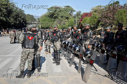 Pakistani Rangers in riot gear stand guard to prevent an anti-government rally, in Islamabad