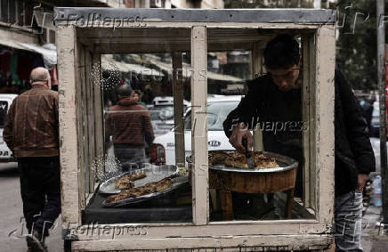 Street vendor sells sweets in downtown of Damascus