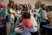 The Three Wise Men visit children and elderly people, ahead of the Epiphany parade, in Ronda