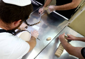 Matza bread is prepared in a bakery ahead of Passover