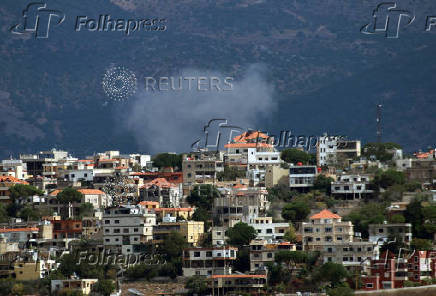 Smoke rises from the southern Lebanese village of Khiam as pictured from Marjayoun