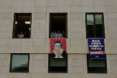 Far-right political party Chega expose banners on the facade of the Portuguese parliament against the wage reinstatement for politicians after the cuts imposed by the Troika, during the debate and vote of the 2025 budget bill on final reading, in Lisbon