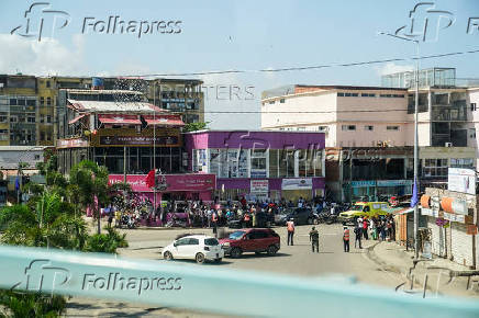 People watch motorcade of U.S. President Joe Biden in Luanda