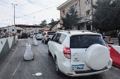 Cars queue to cross into Syria after Syrian rebels announced that they have ousted President Bashar al-Assad, at Masnaa Border Crossing