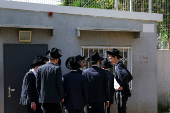 Ultra-Orthodox Jews line up at an Israeli draft office to process their exemptions from mandatory military service at a recruitment base in Kiryat Ono