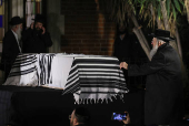 Mourners attend the funeral of Israeli rabbi, Zvi Kogan, in Kfar Habad