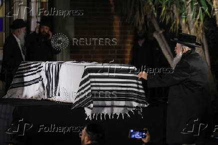 Mourners attend the funeral of Israeli rabbi, Zvi Kogan, in Kfar Habad