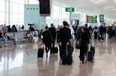 Flight crew members walk along departures area before their flight at Josep Tarradellas Barcelona - El Prat airport in Barcelona