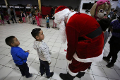 Migrants participate in a Posada ahead of Christmas, in Tijuana