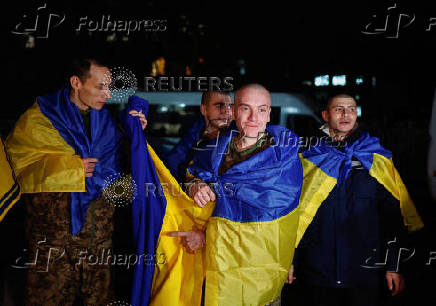 Ukrainian prisoners of war (POWs) return after a swap, in an undisclosed location