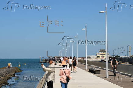 People relax on Melbourne St Kilda beach