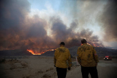 Firefighters and aircraft battle the Hughes Fire near Santa Clarita