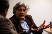 FILE PHOTO: Matiullah Jan, a journalist and columnist, gestures during an interview with Reuters at his office in Islamabad