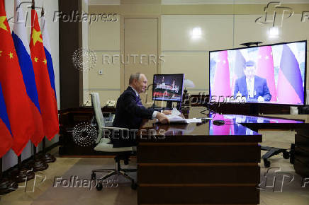 Russian President Vladimir Putin holds a video conference meeting with Chinese President Xi Jinping, outside Moscow