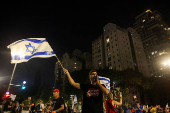 People attend a protest against the government and to show support for the hostages who were kidnapped during the deadly October 7 attack, in Tel Aviv