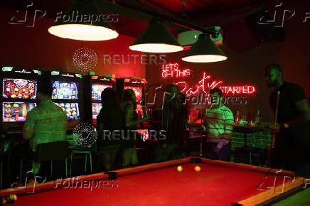 People visit a local pub and casino in Lagos