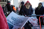 Immigrant rights flyers at a food pantry in Chelsea