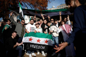 People gather in Washington, after Syrian rebels announced that they have ousted President Bashar al-Assad