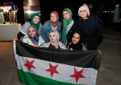 Syrian-Americans and supporters celebrate after Syrian rebels announced that they had ousted Syrian President Bashar al- Assad in Syria, in Dearborn, Michigan,