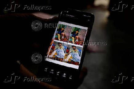 Tofik shows photos of the time he was injured during the Delhi 2020 riots at his residence in Loni town in the northern state of Uttar Pradesh