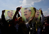 FILE PHOTO: Pro-Kurdish party supporters display flags with portrait of jailed PKK leader Abdullah Ocalan