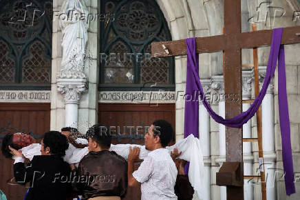 Youth perform a re-enactment of the crucifixion of Jesus Christ during Good Friday at Jakarta Cathedral