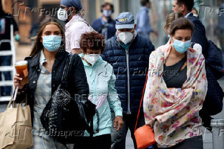 FILE PHOTO: People wear protective face masks as haze and smoke  from Canadian wildfires continues to linger in New York
