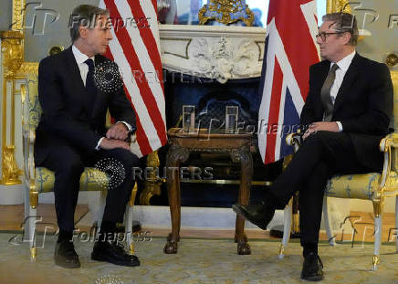 Britain's Prime Minister Keir Starmer listens to U.S. Secretary of State Antony Blinken as they meet at Lancaster House in London